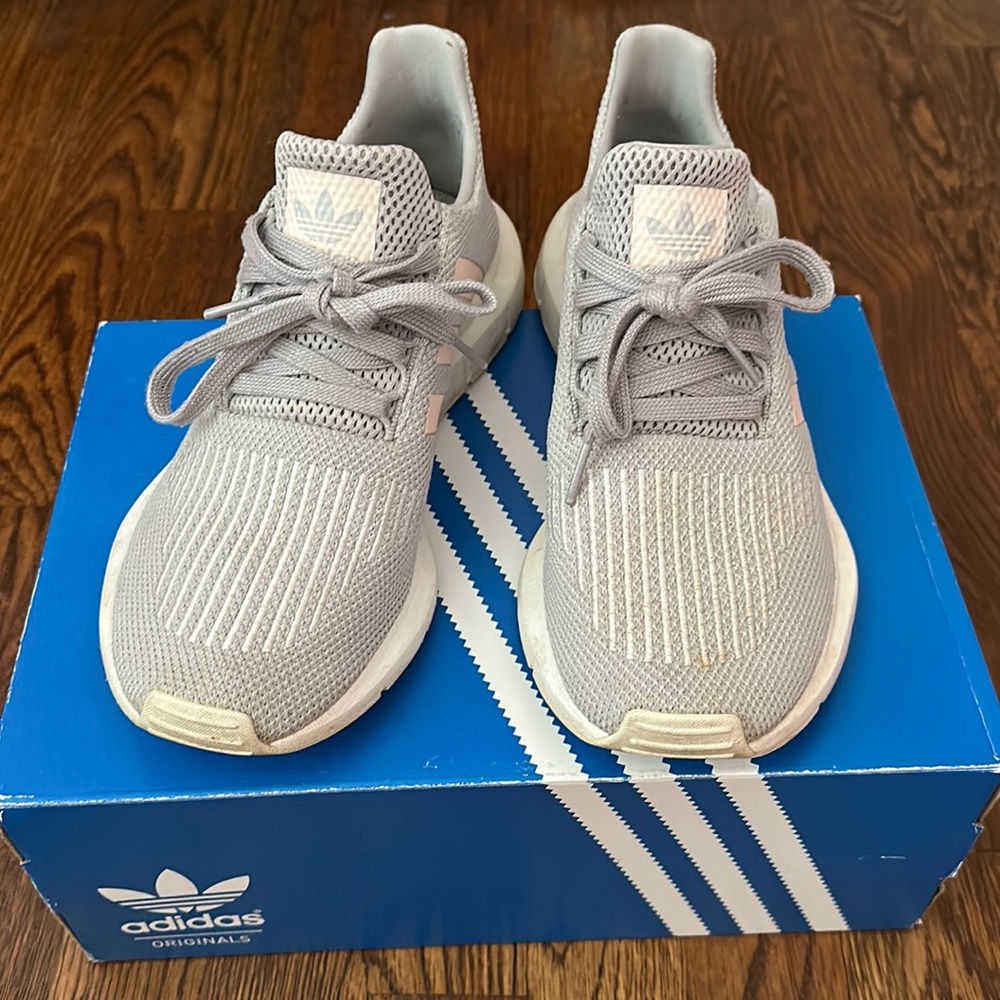 gray and pink Adidas tennis shoes